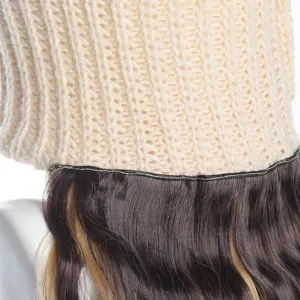 Knit hat with long curly synthetic wig, detailed view of ribbed texture and wavy hair.