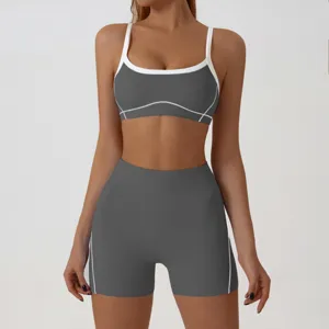 Close-up detail of women athletic sports bra and high waist fitness shorts set in dark grey.