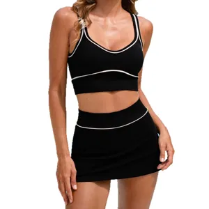Black athletic two piece yoga set with white contrast trim sports bra and mini skirt activewear