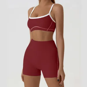 Burgundy athletic yoga set detail showcasing high waist shorts and contrast white trim sports bra.