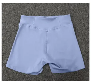 Close-up view of light blue high-waisted fitness shorts, showcasing flexible yoga wear detail.