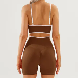 Women contrast color yoga activewear set featuring backless sports bra and fitness shorts details.