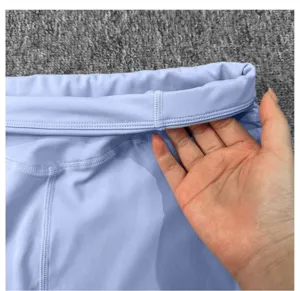 Detailed close-up view of women high waist yoga shorts waistband, light purple activewear.