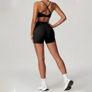Detailansicht des schwarzen Sport-BHs und der High-Waist-Yogashorts mit Kreuzgurt-Rückendesign.