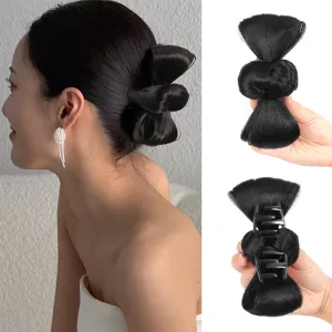 Black bow hair claw clip detail shot showing synthetic hair bun extension and sturdy claw.