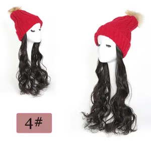 Knit hat wig detail view, soft synthetic long wavy hair with fluffy pom pom, winter.