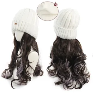 Detail view of the knitted beanie with long wavy synthetic wig, showing fox embroidery and inner lining.