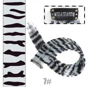Clip-in hair extension detail showing secure metal comb clip and black white animal print.
