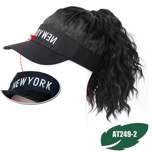 Detail view of black visor hat with curly hair wig extension, featuring stylish embroidery.