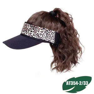 Detail shot of the leopard print sun visor hat with curly synthetic ponytail hair extensions.