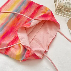 Colorful tie-dye canvas tote bag with pink shoulder straps, casual vibrant daily shoulder bag.