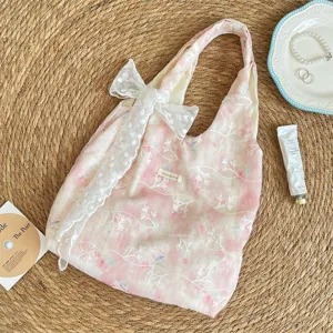 Pink tie-dye canvas shoulder bag featuring cute lace embroidery and bow detail view.