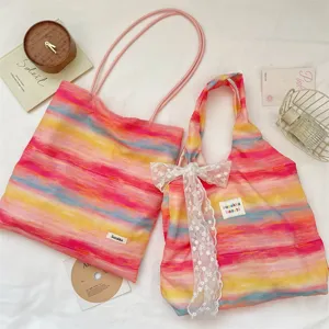 Colorful dopamine gradient stripe canvas tote bag with cute lace bow and shoulder straps.