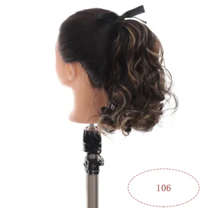 Curly ponytail wig detail with brown highlights and black bow decoration on mannequin head.