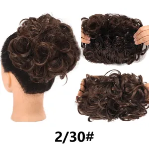 Detailed view of synthetic hair bun extension, showcasing inner net structure and texture.