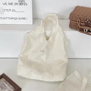 Detailed view of cream floral embroidered tote bag, aesthetic ins style casual fabric handbag.