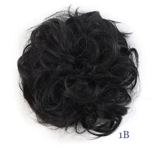 Synthetic messy hair bun detail shot, natural black color 1B, fluffy wavy hairpiece.