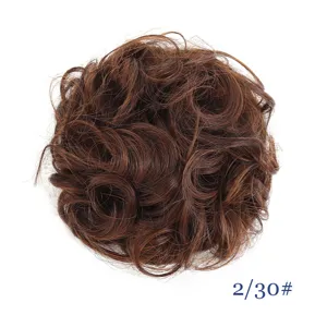Detail view of brown curly synthetic hair bun scrunchie, fluffy messy updo hair piece.