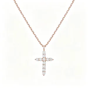 Detailed view of rose gold cross necklace pendant with clear cubic zirconia stones