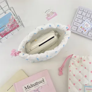 Detailed shot of cute quilted polka dot drawstring storage bag for camera and digital accessories.