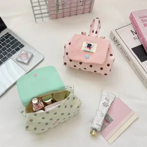 Detailed view of cute polka dot cosmetic bags with flap and handle, perfect for daily use.