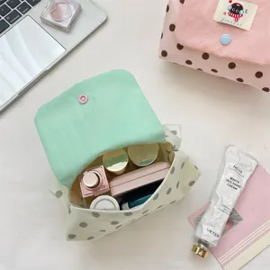 Cute polka dot cosmetic bag with flap, portable makeup pouch and travel storage for daily use.