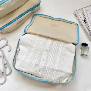 Beige Reiseaufbewahrungstasche mit blauem Reißverschluss für Kleidung und Reiseorganisation