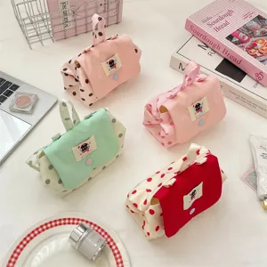 Cute polka dot cosmetic bag with handle and cartoon patch, portable makeup storage pouch.