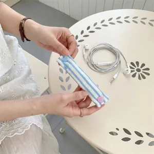 Blue white striped cable organizer strap with snap button for neat data wire management.