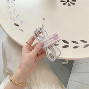 Adorable pink heart snap cable organizer strap for data cords and neat desk storage.