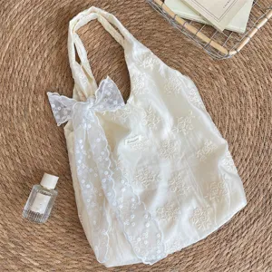 Cream white floral embroidered canvas tote bag with delicate lace bow for daily wear.