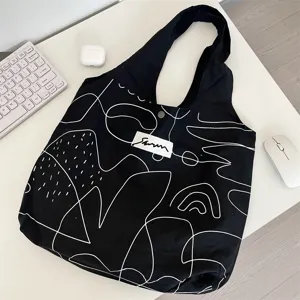 Zwarte canvas shopper tas met witte abstracte lijnkunst design minimalistische casual boekentas