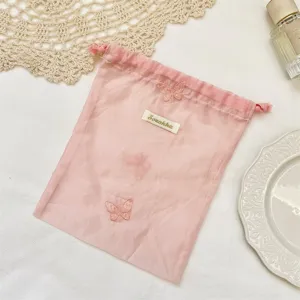Roze organza opbergtas met prachtige vlinderborduurwerk voor cosmetica en dagelijkse sieraden.