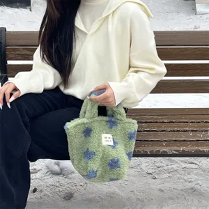 Winter cute green plush handbag with blue floral pattern, soft fluffy fabric, small tote bag.