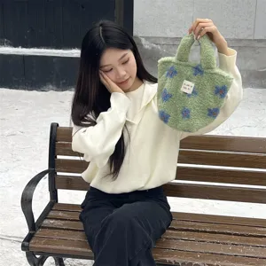 Cute Korean style fuzzy handbag for women winter plush tote bag with lovely blue floral pattern detail.