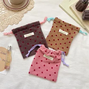 Velvet polka dot drawstring storage bag, contrast color cords, ideal for travel jewelry and cosmetics.