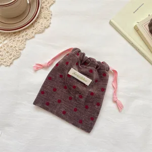 Velvet polka dot drawstring pouch detail, cute pink contrast strings for jewelry storage.