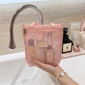 Pink mesh cosmetic bag with zipper and handle, portable travel toiletry organizer pouch.