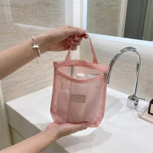 Pink mesh cosmetic bag with zipper and handle, portable travel toiletry pouch for daily storage.