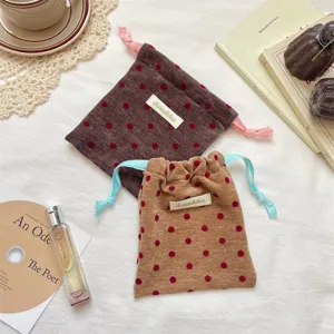 Portable velvet polka dot drawstring bag, contrast design for travel jewelry cosmetics storage.
