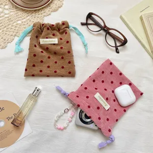 Portable velvet polka dot drawstring storage bag for jewelry, cosmetics, and travel essentials.
