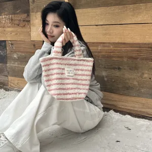 Cute pink striped plush handbag for women, soft fuzzy winter mini tote bag for daily use.