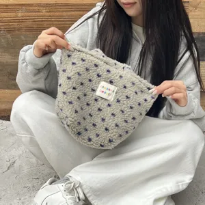 Detail view of the cute plush handbag featuring soft fuzzy texture and cute blue floral pattern.
