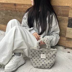 Detail view of a cozy plush handbag with cute star patterns, perfect for winter daily wear.