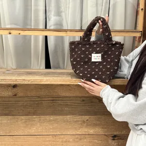 Brown fuzzy plush handbag detail, cute patterned winter small tote bag with top handle.