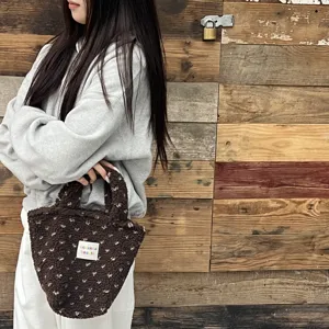 Detail view of the winter brown plush handbag, showcasing soft fuzzy fabric and brand label.