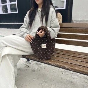 Detailed close-up view of brown plush handbag, cute fuzzy tote bag for winter daily style.