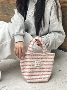 Cute fuzzy striped handbag for women, soft plush tote bag for winter daily casual use.
