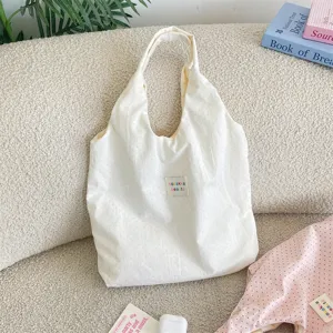 Cream white polka dot canvas tote bag detail shot showing soft fabric texture and lazy casual style.