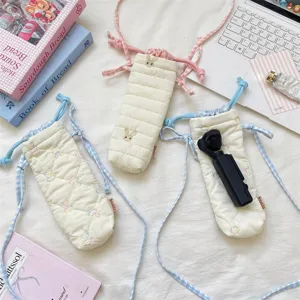 Korean style quilted camera bag with cute heart pattern, drawstring closure and crossbody strap.